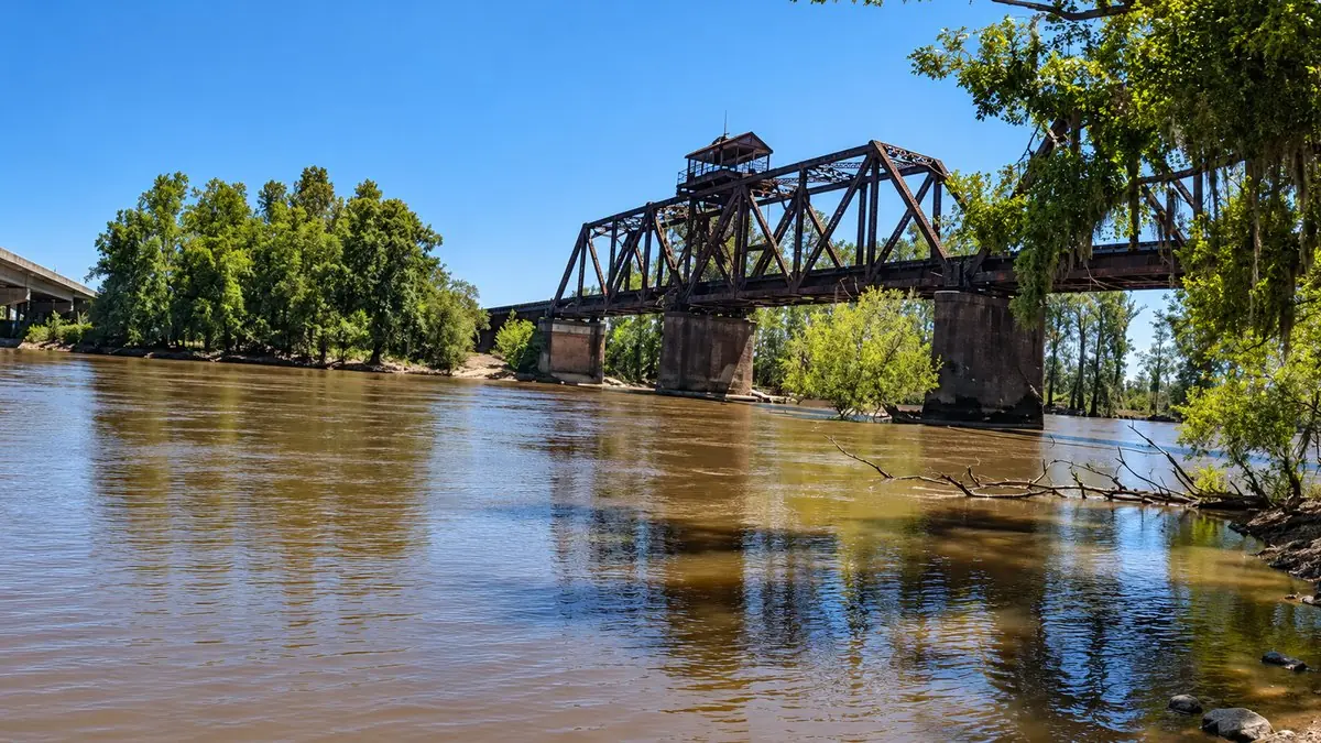 The old swing-span railroad bridge over the wide brown Ocmulgee